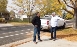 A licensed roof contractor talking with a homeowner about roofing options.
